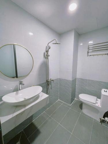 a bathroom with a sink and a mirror at Bống's Homesray and café in Ho Chi Minh City