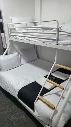 a couple of bunk beds in a room at Holiday Plus - 50 Palatine Road in Blackpool
