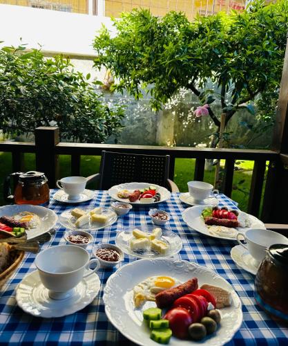 a blue and white table topped with plates of food at Bujtina Valgent in Berat