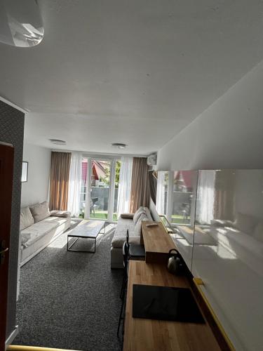 a living room with a couch and a table at SANSET APART Okuninka in Okuninka