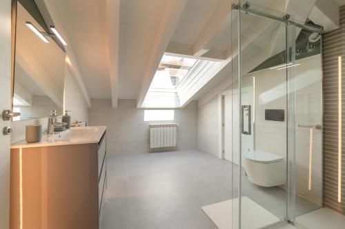a bathroom with a shower and a sink and a toilet at Apartamentos Villa De Comillas in Comillas