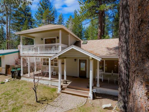 a white house with a porch and a balcony at Royal Retreat Quiet & Cozy in South Lake Tahoe