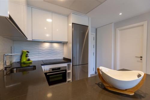 a kitchen with a tub in the middle of a kitchen at Nicolas in Casas Devesa