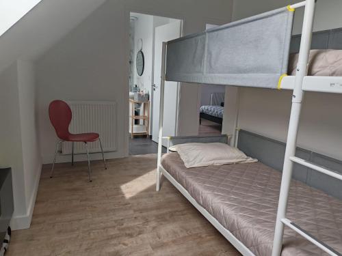 a bedroom with a bunk bed and a chair at YDIWEN Maison Tregunc in Trégunc