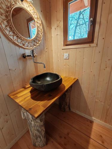 a bathroom with a black sink on a wooden table at Camping le Colorado in Rustrel