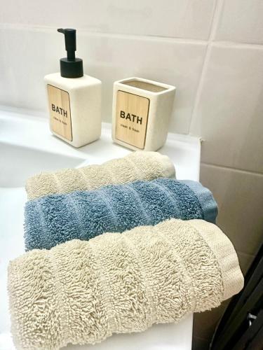 two towels and a soap dispenser on a shelf in a bathroom at Balansea Resort in Caesarea