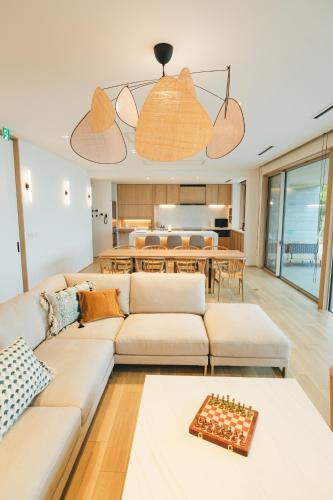 a living room with a couch and a table at SHIMASTREAM house in Shodoshima