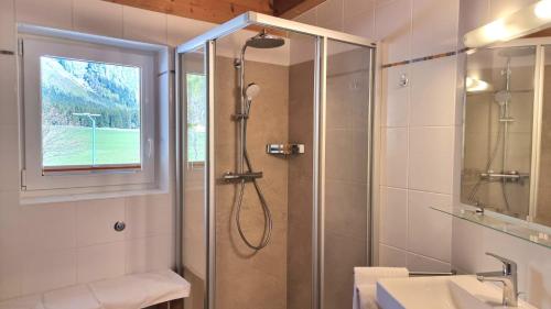 a bathroom with a shower with a glass door at Appartements Erhol dich gut in Leutasch