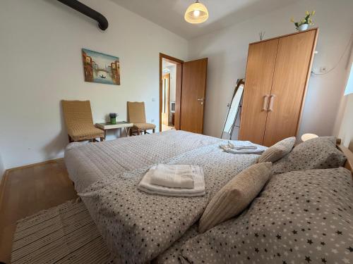 a bedroom with a bed with a blanket on it at Apartments Avram in Vršac