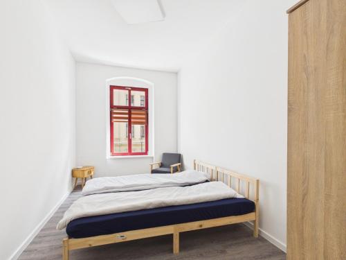 a bedroom with a bed and a chair in it at Landeskron38 - LK38 in Görlitz