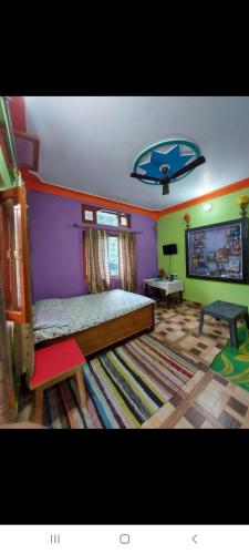a bedroom with a bed and a table and a rug at PeaceVibe Homestay in Uttarkāshi