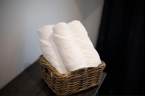 a basket filled with towels sitting on a table at Silver Stone Studio Apartments in Gjirokastër
