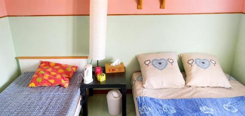 a small bedroom with two beds and a night stand at Le bois saint Hilaire in Lémeré