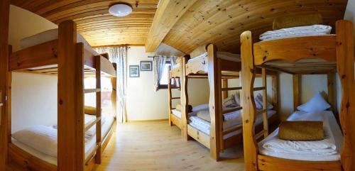 a room with four bunk beds in a cabin at Galtalm in Fulpmes