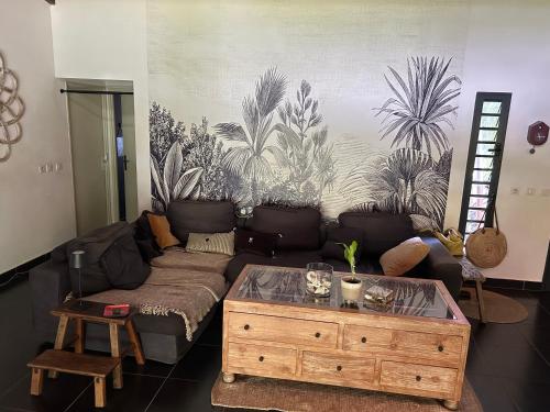 a living room with a couch and a coffee table at Chambre De L étang in Saint-Paul