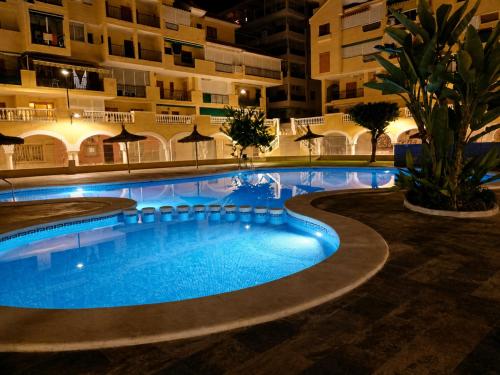 a swimming pool in a hotel at night at ESTUDIO Torrevieja P & A - Piscina y Playa La Mata 3 min in La Mata
