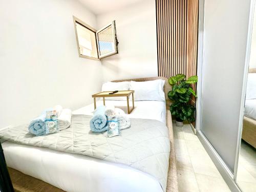 a hotel room with towels on a bed at Balansea Resort in Caesarea