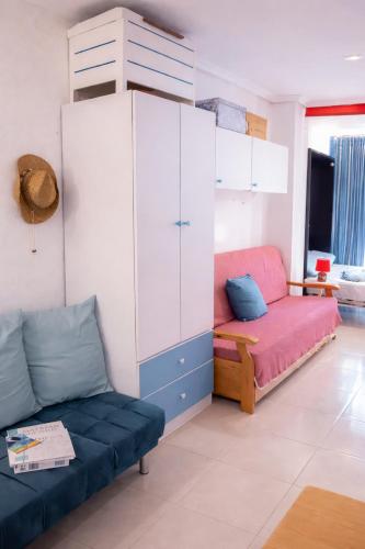 a living room with a couch and a cabinet at ESTUDIO Torrevieja P & A - Piscina y Playa La Mata 3 min in La Mata
