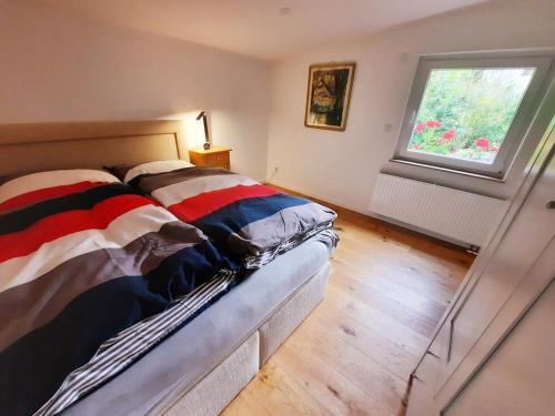 a bed in a room with a window at Modern apartment Selm Cappenberg in Selm