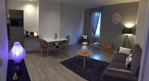 - un salon avec un canapé et une table dans l'établissement Appartement des Nuages Jademarg, à Bègles