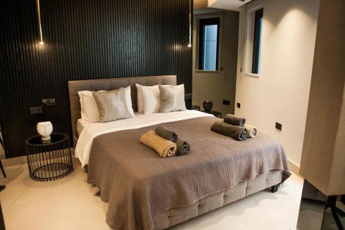 a bedroom with a large bed with towels on it at Raam Luxury Suites in Larnaca