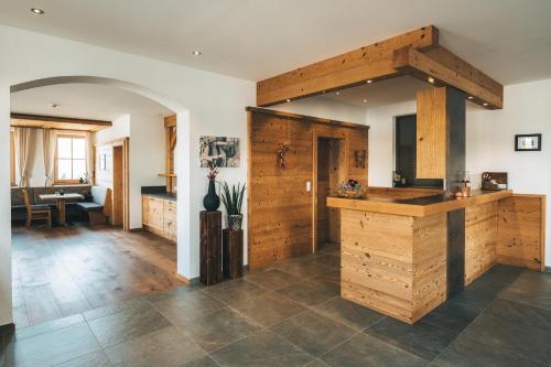 a large kitchen with wooden cabinets and a counter at Appartements Alexander in Fiss