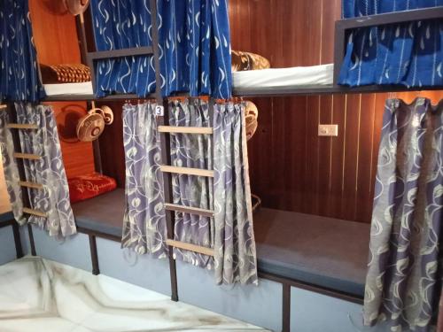 a room with two bunk beds and a ladder at Backpackers Station in Jammu