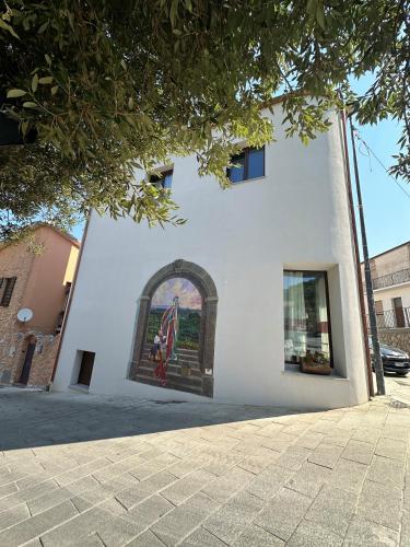 a building with a mural on the side of it at ANTICHE TERRE Di GALLURA in Monti