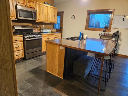 a kitchen with wooden cabinets and a counter top at River View Upstairs Apartment in Kenai