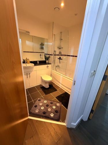 a bathroom with a shower and a toilet and a sink at Cozy One bedroom with Free Underground parking in Mailbox Birmingham city in Birmingham