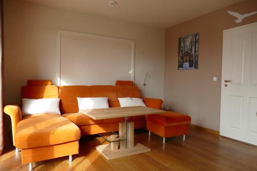 a living room with a couch and a table at Adele in Zingst