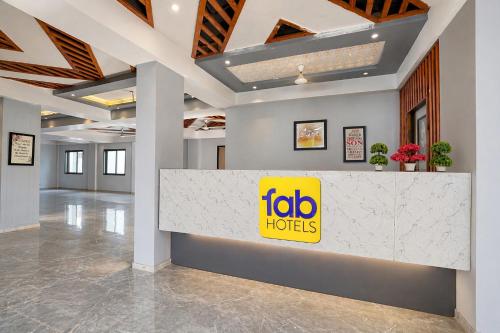 a lobby with a mobo hotel sign on a counter at FabHotel Kalptaru in Pune