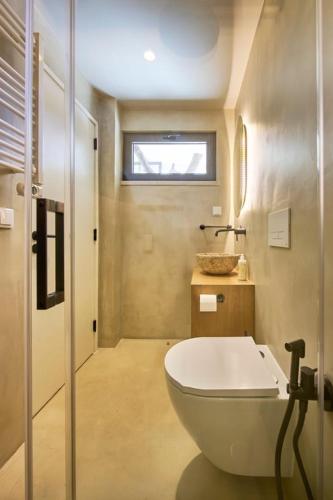 a bathroom with a white tub and a sink at Casa Redonda by Villas Aura - Retreat 2 in Aroeira