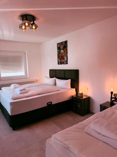 a bedroom with two beds and a window at Parkside Apartments Rust in Rust