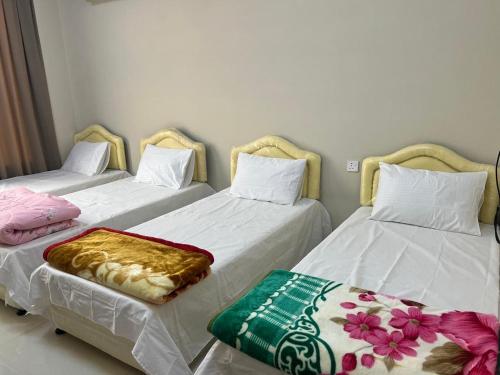 two beds sitting next to each other in a room at صلالة مرباط in Mirbāţ