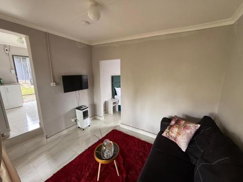 a living room with a couch and a tv at Vumasky self catering in Ladysmith