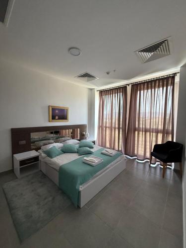 a bedroom with a large bed with green pillows at Dorana Hotel Lefkoşa in Lefkosa Turk