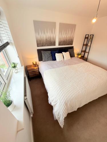 a bedroom with a large bed and a window at The Vine in Powick