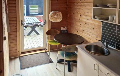 a small kitchen with a sink and a table at Beautiful Apartment In Farsø in Farsø