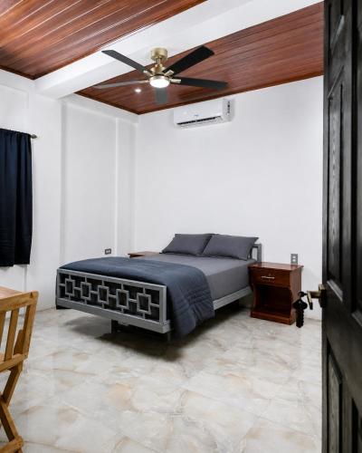 a bedroom with a bed with a ceiling fan at Hotel Loma Linda in Ocotal