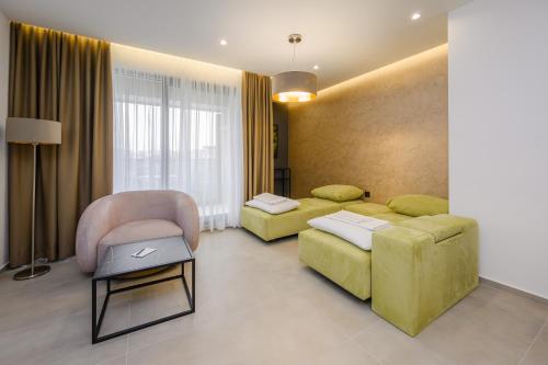 a living room with a couch and a chair at Aurelia Residence in Metković