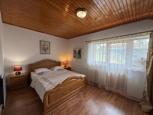 a bedroom with a large bed and a window at Guest House Danver in Yaremche