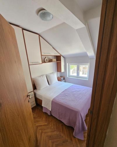 a bedroom with a bed and a window at Žana in Kotor