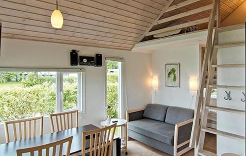 a living room with a couch and a table at Nice Apartment In Farsø With Heated Swimming Pool in Farsø