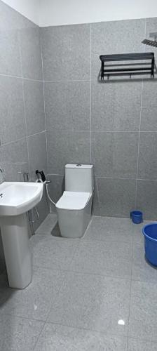 a bathroom with a toilet and a sink at The Royal Vintage Resort in Majhola