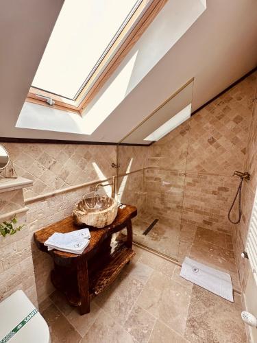 a bathroom with a shower with a wooden table at Domeniul Mortasifu in Nişcov