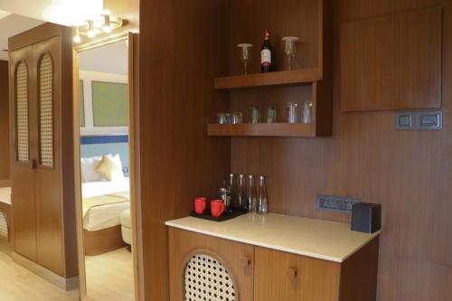 a room with a bedroom with a bed and a counter at Sterling Ooty Elk Hill in Ooty