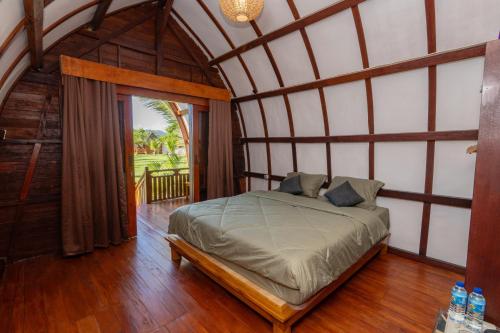a bedroom with a large bed in a room at Heyho Bungalow in Maluk