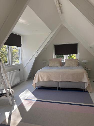 a bedroom with a large bed in a attic at Blossom in Bergen