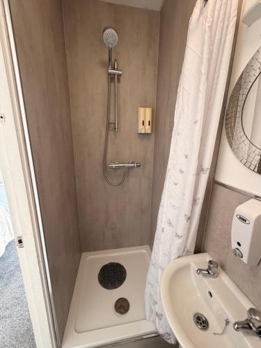 a bathroom with a shower and a sink at The Avenue GuestHouse in Newcastle upon Tyne